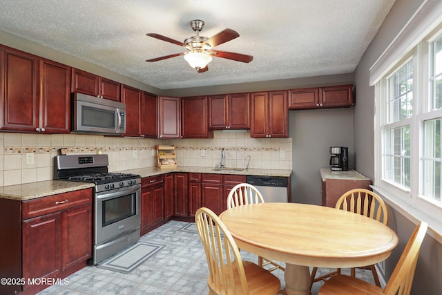 1184 Rachel Ct, Brick, NJ 08724 - kitchen featuring appliances with stainless steel finishes, reddish brown cabinets, a sink, and a textured ceiling