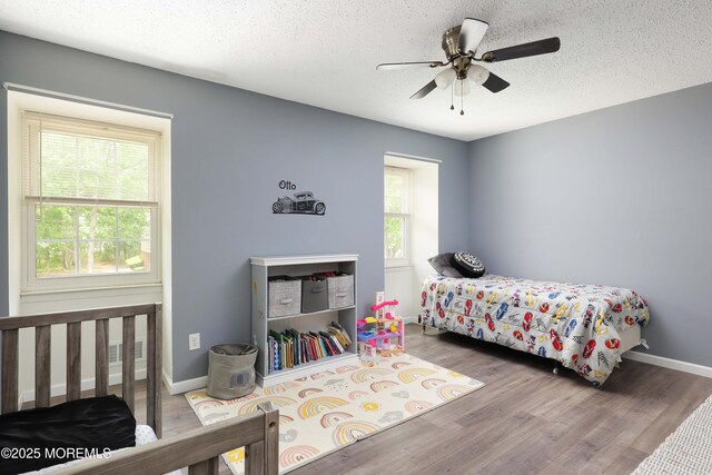 1184 Rachel Ct, Brick, NJ 08724 - bedroom featuring wood finished floors, a textured ceiling, baseboards, and a ceiling fan