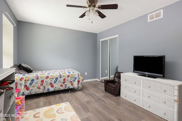 1184 Rachel Ct, Brick, NJ 08724 - bedroom with wood finished floors, a closet, a ceiling fan, a textured ceiling, and baseboards