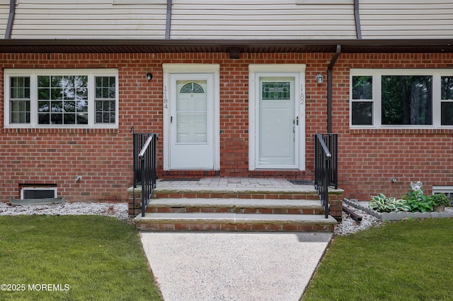 1184 Rachel Ct, Brick, NJ 08724 - view of exterior entry with brick siding and a lawn