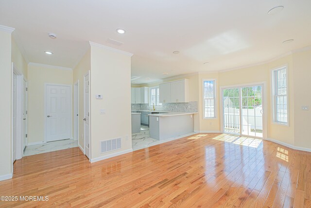 147 Old Bridge Tpke, East Brunswick, NJ 08816 - unfurnished living room with light wood-type flooring, ornamental molding, baseboards, and recessed lighting