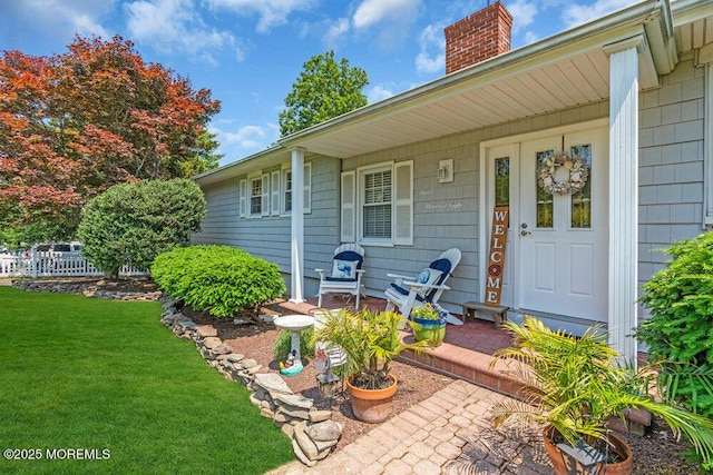708 Schoolhouse Rd, Brielle, NJ 08730 - property entrance featuring covered porch, a yard, and a chimney