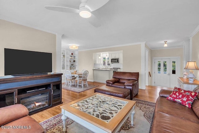 708 Schoolhouse Rd, Brielle, NJ 08730 - living room featuring light wood-type flooring, ornamental molding, a ceiling fan, and built in features
