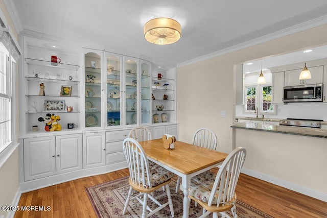 708 Schoolhouse Rd, Brielle, NJ 08730 - dining room featuring light wood finished floors and crown molding
