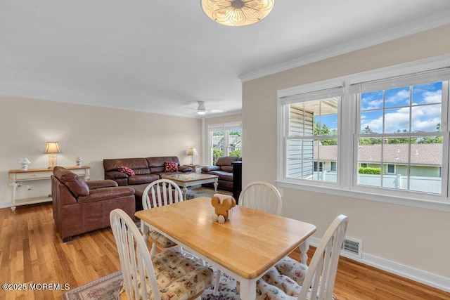 708 Schoolhouse Rd, Brielle, NJ 08730 - dining space with light wood-style flooring, crown molding, and a ceiling fan