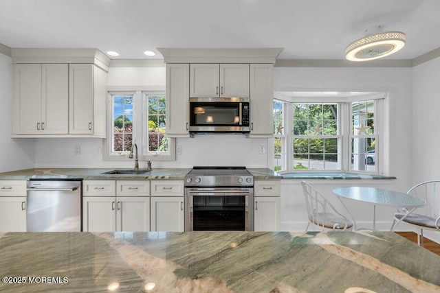 708 Schoolhouse Rd, Brielle, NJ 08730 - kitchen with appliances with stainless steel finishes, light stone counters, recessed lighting, and white cabinets