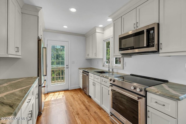 708 Schoolhouse Rd, Brielle, NJ 08730 - kitchen featuring appliances with stainless steel finishes, recessed lighting, light wood finished floors, and white cabinetry