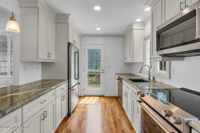 708 Schoolhouse Rd, Brielle, NJ 08730 - kitchen featuring appliances with stainless steel finishes, healthy amount of natural light, dark stone counters, white cabinets, and recessed lighting