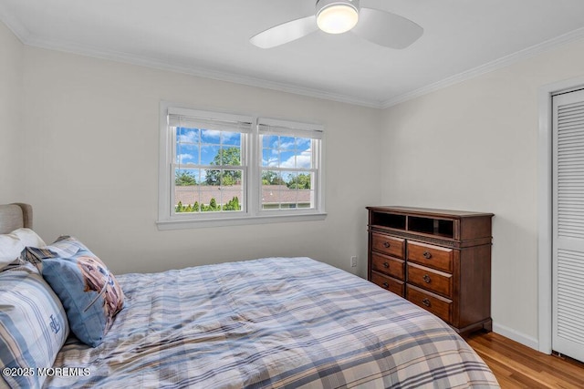 708 Schoolhouse Rd, Brielle, NJ 08730 - bedroom featuring wood finished floors, ornamental molding, a ceiling fan, and a closet