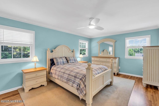 708 Schoolhouse Rd, Brielle, NJ 08730 - bedroom featuring multiple windows, wood finished floors, ceiling fan, and crown molding