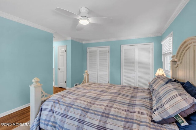 708 Schoolhouse Rd, Brielle, NJ 08730 - bedroom with multiple closets, wood finished floors, crown molding, and a ceiling fan