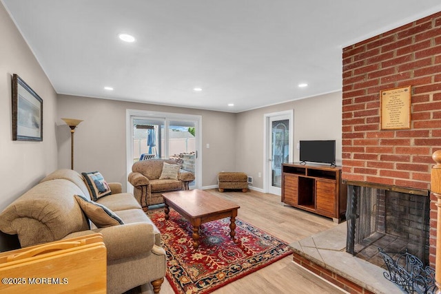 708 Schoolhouse Rd, Brielle, NJ 08730 - living room with light wood-type flooring, recessed lighting, and a brick fireplace
