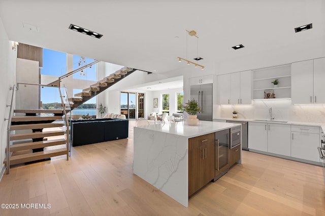 4 Boat Club Ct Unit 3E, Red Bank, NJ 07701 - kitchen with open shelves, modern cabinets, light wood finished floors, open floor plan, and white cabinets