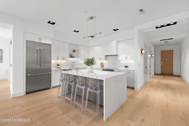 4 Boat Club Ct Unit 3E, Red Bank, NJ 07701 - kitchen featuring high end refrigerator, open shelves, light wood-style flooring, and tasteful backsplash