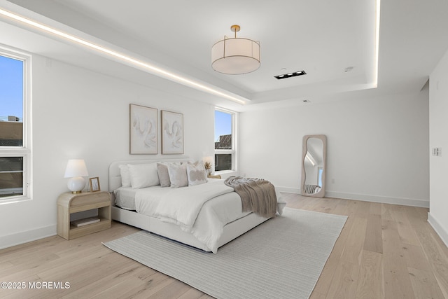4 Boat Club Ct Unit 3E, Red Bank, NJ 07701 - bedroom with a tray ceiling and light wood-style floors
