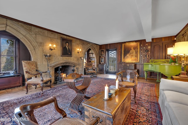 310 Cooper Rd Unit C, Red Bank, NJ 07701 - living room featuring a fireplace, wooden walls, beamed ceiling, ornamental molding, and arched walkways