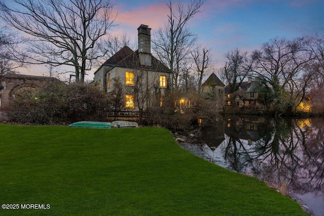 310 Cooper Rd Unit C, Red Bank, NJ 07701 - back of property at dusk featuring a yard and a chimney