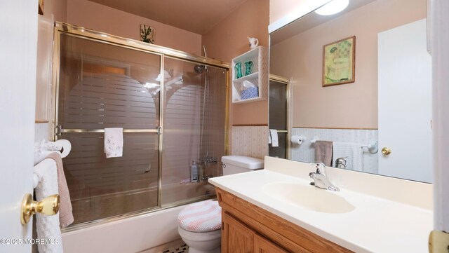 277 Grandview Ave, Piscataway Twp, NJ 08854 - bathroom featuring toilet, vanity, bath / shower combo with glass door, and a wainscoted wall