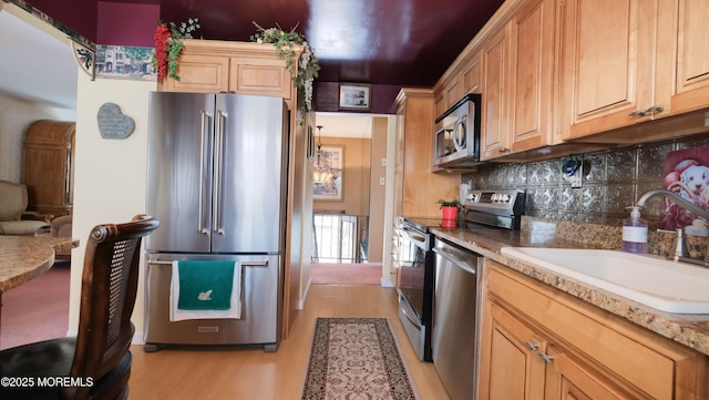 277 Grandview Ave, Piscataway Twp, NJ 08854 - kitchen featuring stainless steel appliances, a sink, light wood-style flooring, decorative backsplash, and light countertops