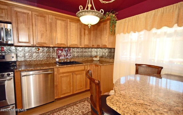 277 Grandview Ave, Piscataway Twp, NJ 08854 - kitchen with appliances with stainless steel finishes, a sink, stone countertops, backsplash, and brown cabinetry