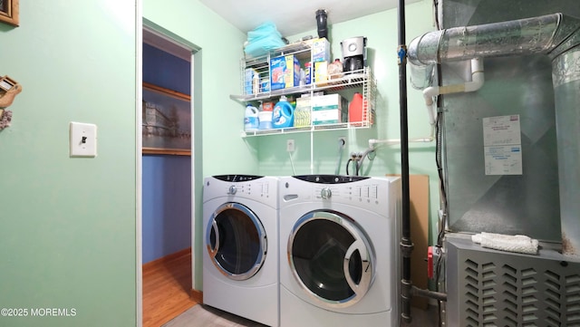 277 Grandview Ave, Piscataway Twp, NJ 08854 - laundry room with washing machine and dryer, wood finished floors, and heating unit