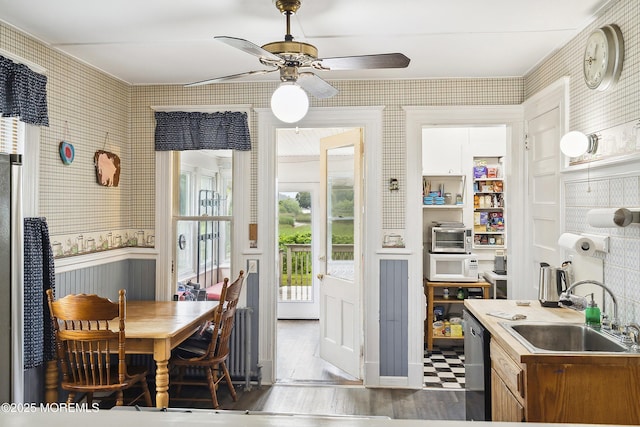 699 River Rd, Fair Haven, NJ 07704 - dining area with ceiling fan, wallpapered walls, and a wainscoted wall