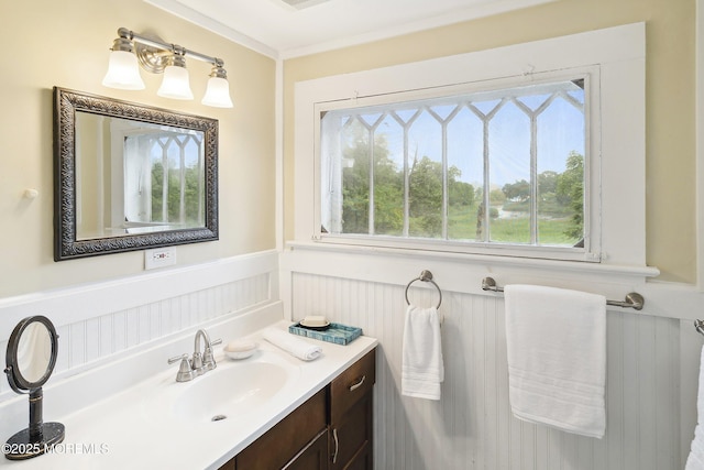 699 River Rd, Fair Haven, NJ 07704 - bathroom featuring vanity, wainscoting, a decorative wall, and crown molding