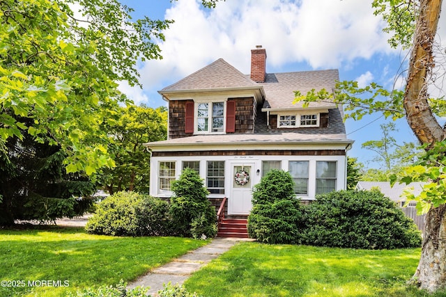 699 River Rd, Fair Haven, NJ 07704 - view of front of house with a chimney, a shingled roof, and a front lawn