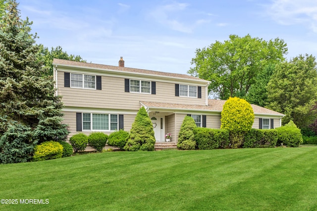 24 Sugar Maple Dr, Red Bank, NJ 07701 - view of front of house with a chimney, a front lawn, and roof with shingles