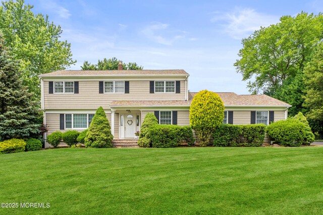 24 Sugar Maple Dr, Red Bank, NJ 07701 - view of front of house with a front lawn, a chimney, and roof with shingles