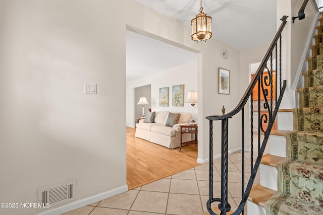 24 Sugar Maple Dr, Red Bank, NJ 07701 - stairs featuring tile patterned flooring and a chandelier