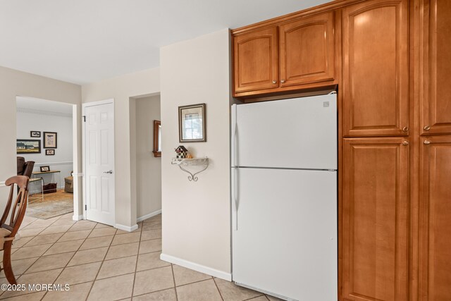 24 Sugar Maple Dr, Red Bank, NJ 07701 - kitchen with freestanding refrigerator, light tile patterned floors, and brown cabinets