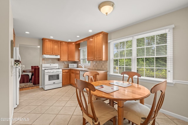 24 Sugar Maple Dr, Red Bank, NJ 07701 - kitchen with white gas range, under cabinet range hood, light tile patterned floors, light countertops, and decorative backsplash