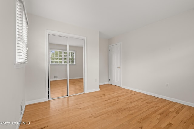 24 Sugar Maple Dr, Red Bank, NJ 07701 - unfurnished bedroom with light wood finished floors and a closet