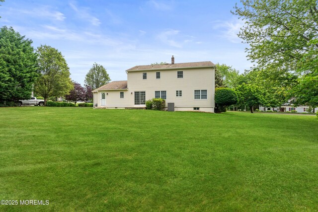 24 Sugar Maple Dr, Red Bank, NJ 07701 - back of property with a yard and a chimney