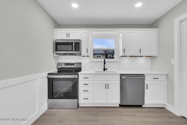 84 Briar Mills Dr, Brick, NJ 08724 - kitchen featuring appliances with stainless steel finishes, a sink, tasteful backsplash, white cabinets, and recessed lighting