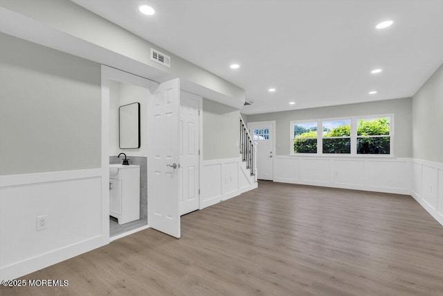 84 Briar Mills Dr, Brick, NJ 08724 - spare room featuring wainscoting, a decorative wall, stairs, light wood-style flooring, and recessed lighting