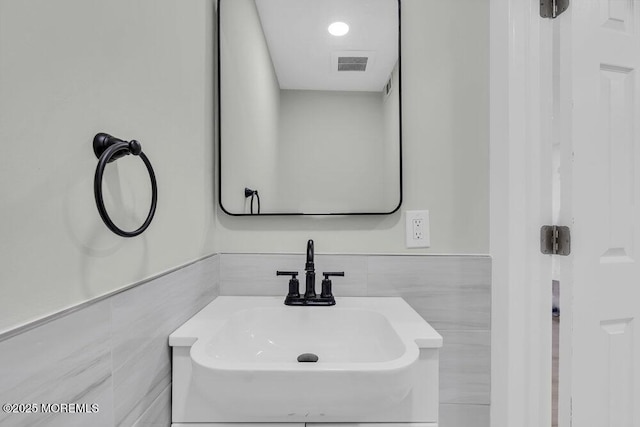 84 Briar Mills Dr, Brick, NJ 08724 - bathroom with a sink, tile walls, and a wainscoted wall