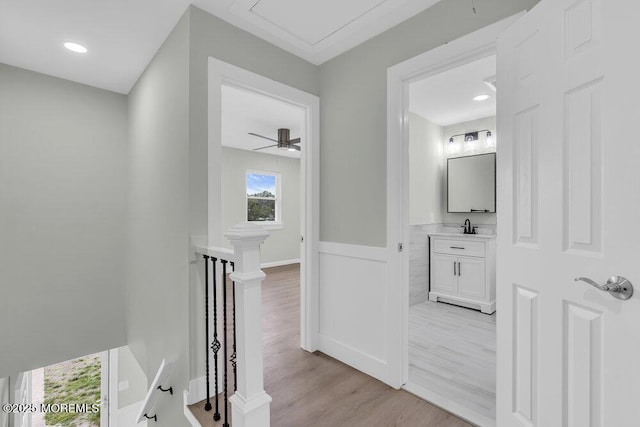 84 Briar Mills Dr, Brick, NJ 08724 - corridor with an upstairs landing, light wood finished floors, wainscoting, and a sink