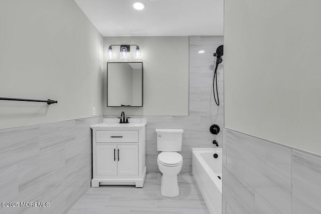 84 Briar Mills Dr, Brick, NJ 08724 - bathroom featuring tile walls, vanity, toilet, tub / shower combination, and a wainscoted wall