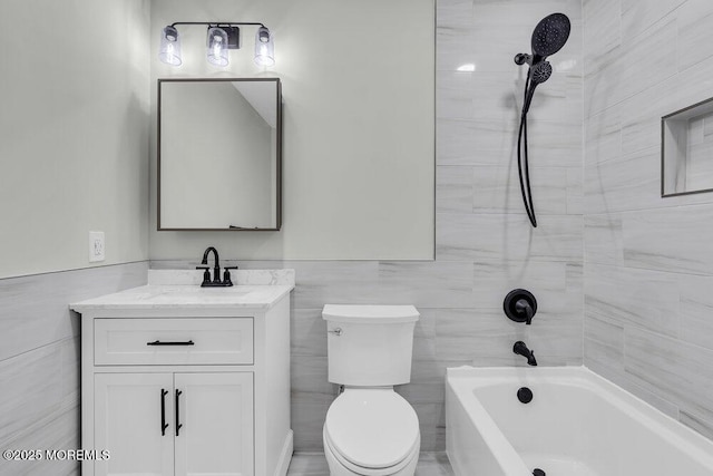 84 Briar Mills Dr, Brick, NJ 08724 - bathroom featuring vanity, toilet, tile walls, bathtub / shower combination, and a wainscoted wall