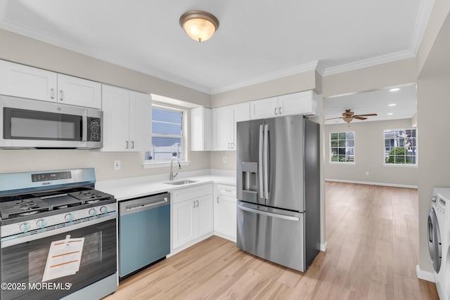 34-1 Green Grove Ave, Keyport, NJ 07735 - kitchen featuring stainless steel appliances, washer / dryer, light wood-style flooring, crown molding, and light countertops