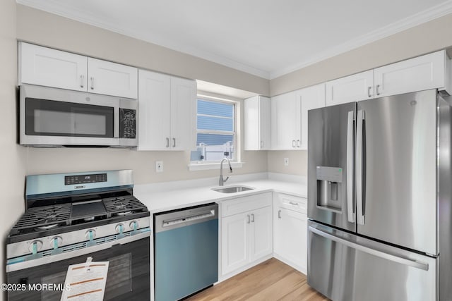 34-1 Green Grove Ave, Keyport, NJ 07735 - kitchen with stainless steel appliances, crown molding, light countertops, white cabinets, and light wood finished floors