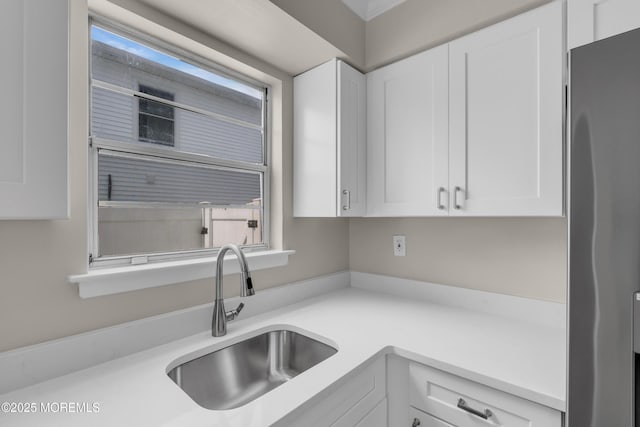 34-1 Green Grove Ave, Keyport, NJ 07735 - kitchen featuring freestanding refrigerator, white cabinetry, light countertops, and healthy amount of natural light
