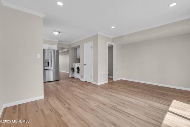 34-1 Green Grove Ave, Keyport, NJ 07735 - unfurnished living room with washing machine and dryer, crown molding, light wood-style floors, and recessed lighting