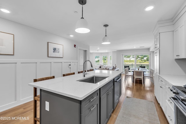 150 Ocean Ave Unit 6, Sea Bright, NJ 07760 - kitchen featuring gray cabinets, high end stainless steel range oven, light wood-style flooring, a kitchen breakfast bar, and recessed lighting