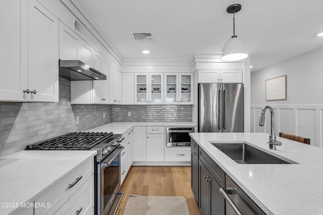 150 Ocean Ave Unit 6, Sea Bright, NJ 07760 - kitchen with stainless steel appliances, range hood, white cabinetry, a wainscoted wall, and recessed lighting