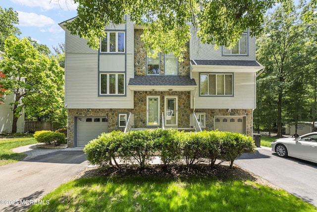 35 Lone Star Ln, Manalapan, NJ 07726 - view of front of home with stone siding, a garage, and driveway