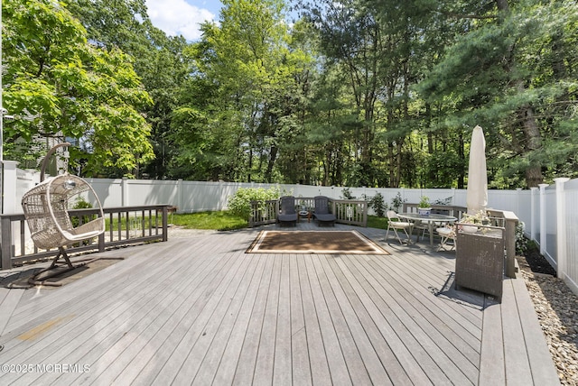 35 Lone Star Ln, Manalapan, NJ 07726 - wooden terrace with outdoor dining space, a fenced backyard, and view of scattered trees