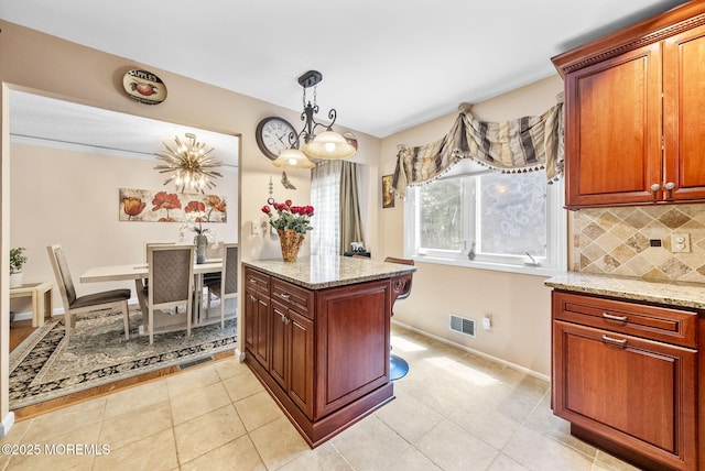 35 Lone Star Ln, Manalapan, NJ 07726 - kitchen with decorative backsplash, light stone countertops, pendant lighting, and baseboards
